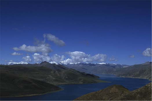 Yamdrog lake, from the Gampala pass. In the background is Nojin Gansang, the mountain god protecting the Yamdrog area 
